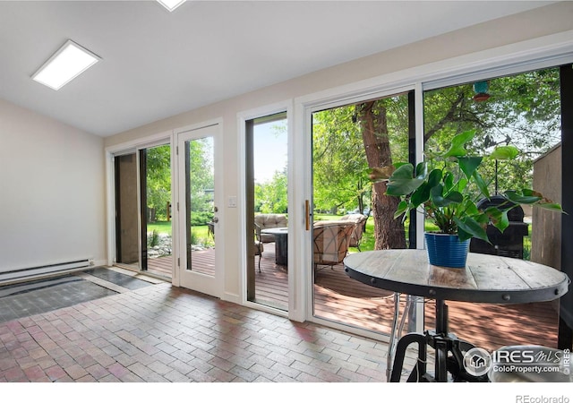 entryway with a baseboard heating unit and lofted ceiling