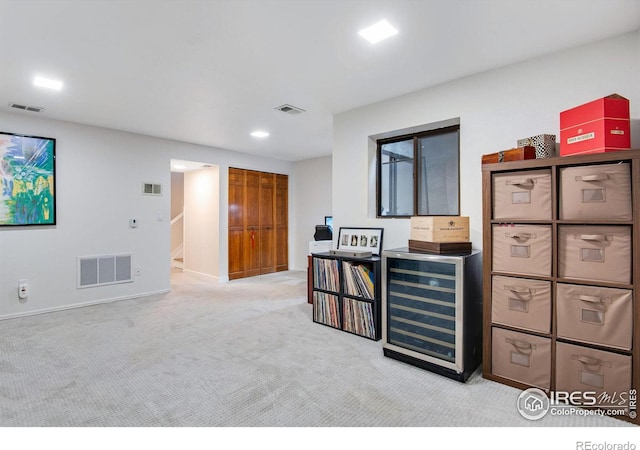 interior space featuring light carpet and beverage cooler