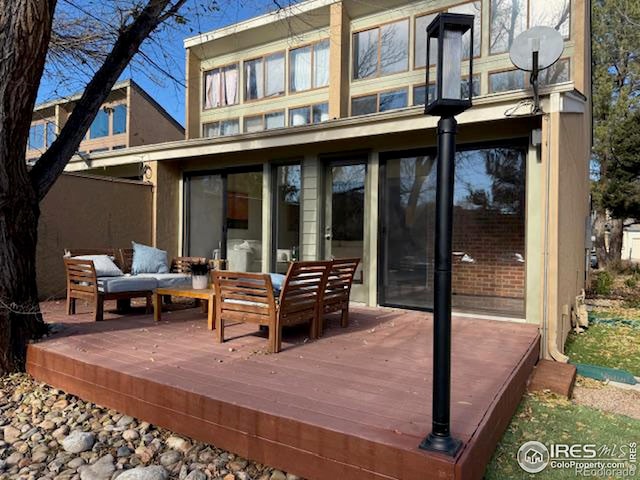 back of house featuring outdoor lounge area and a wooden deck