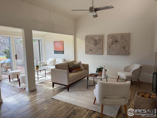 living room featuring wood-type flooring and ceiling fan