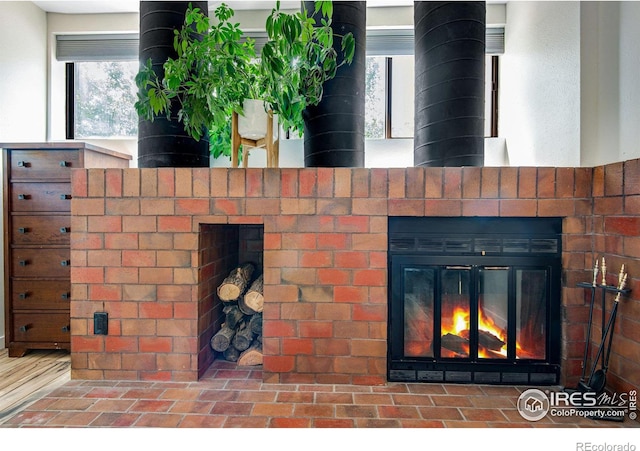 interior details with a brick fireplace