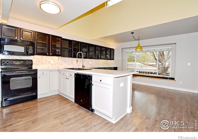 kitchen with light hardwood / wood-style floors, sink, black appliances, tasteful backsplash, and white cabinets