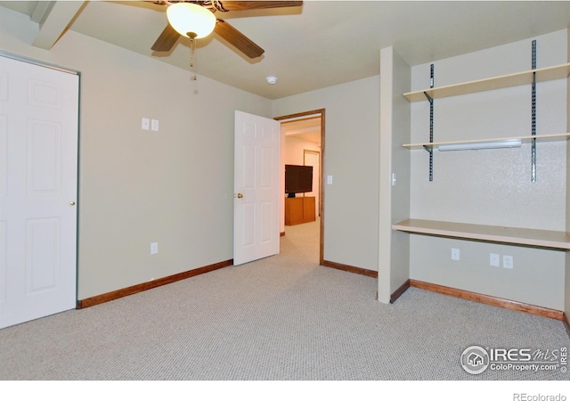 unfurnished bedroom featuring ceiling fan and light carpet