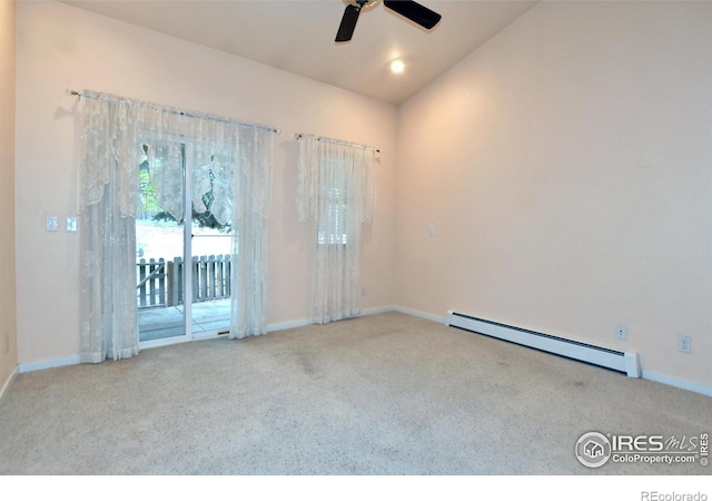 carpeted spare room featuring vaulted ceiling, ceiling fan, and a baseboard radiator