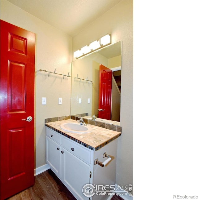 bathroom with vanity and hardwood / wood-style floors