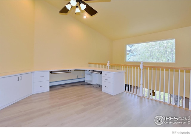 unfurnished office featuring baseboard heating, light wood-type flooring, ceiling fan, and built in desk