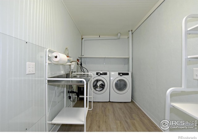 laundry area with hardwood / wood-style floors and separate washer and dryer