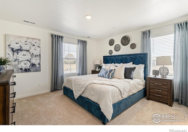 bedroom with light colored carpet