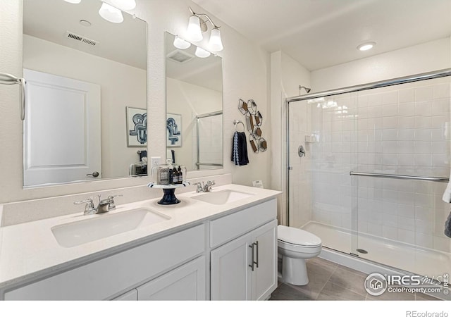 bathroom with walk in shower, tile patterned floors, toilet, and vanity