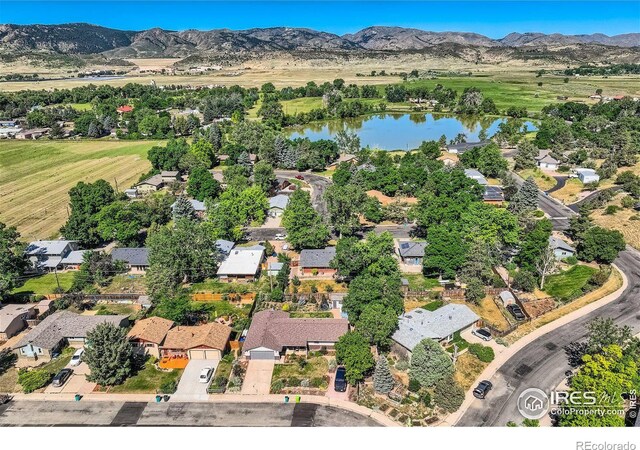 birds eye view of property featuring a water and mountain view and a residential view