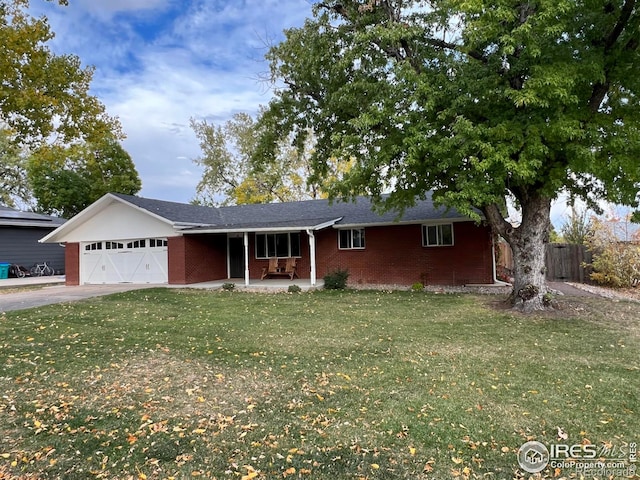 ranch-style home featuring a garage and a front lawn