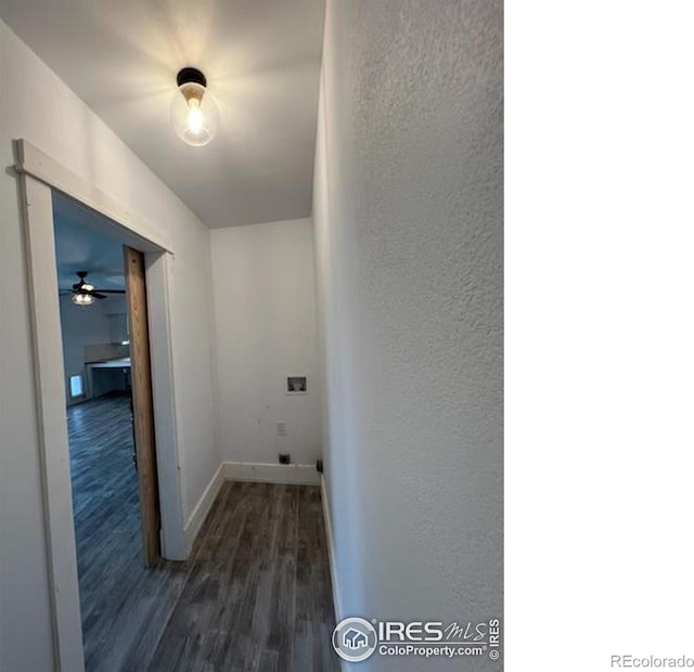 laundry room with a textured wall, hookup for a washing machine, laundry area, wood finished floors, and baseboards