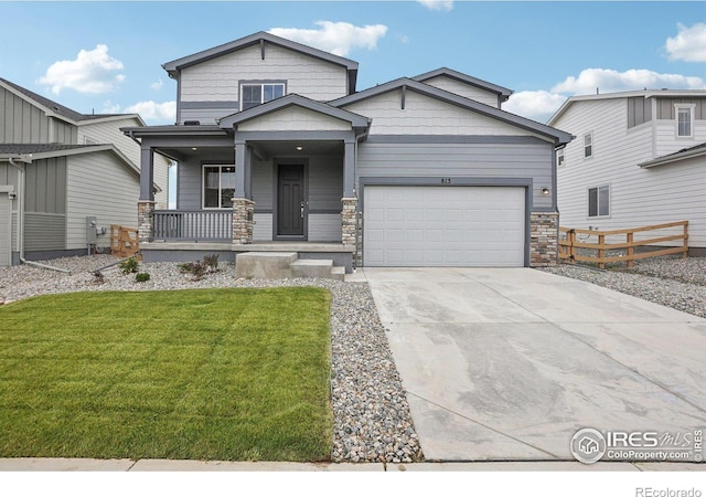 view of front of property with a garage, a porch, and a front lawn