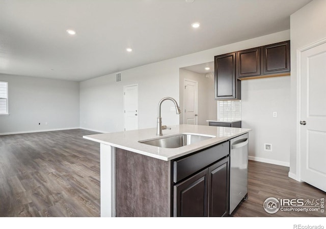 kitchen with dishwasher, dark wood-style floors, light countertops, dark brown cabinets, and a sink