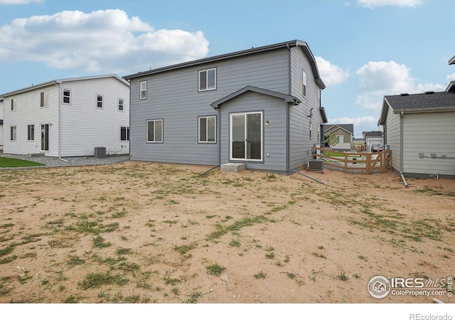 back of house with fence and central AC unit