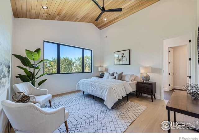 bedroom with high vaulted ceiling, wooden ceiling, and light wood-type flooring