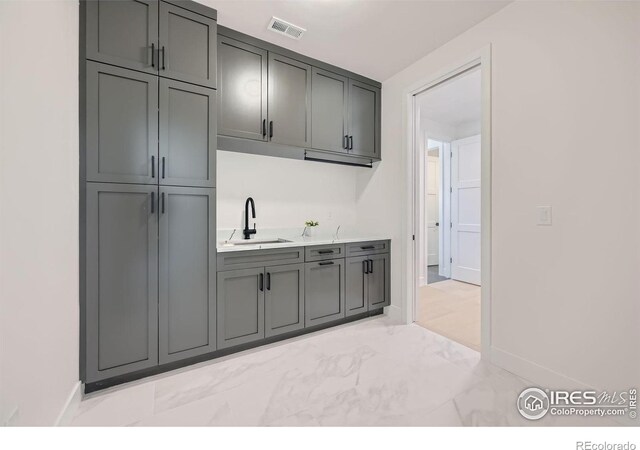 kitchen with sink and gray cabinetry