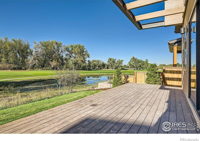 wooden terrace featuring a water view