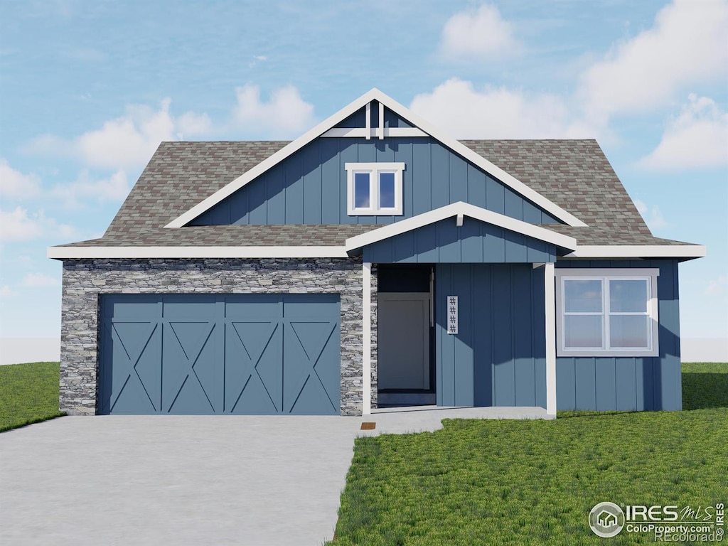 view of front of home featuring a front yard and a garage