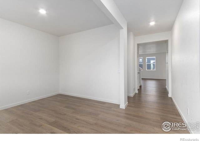 unfurnished room with hardwood / wood-style flooring