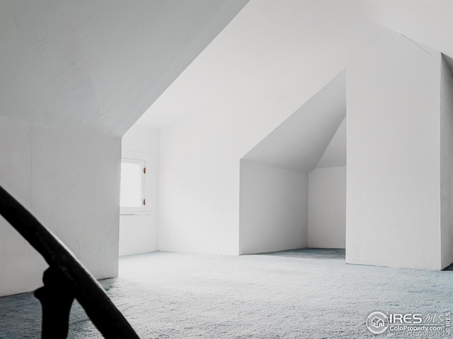 bonus room with carpet floors and lofted ceiling