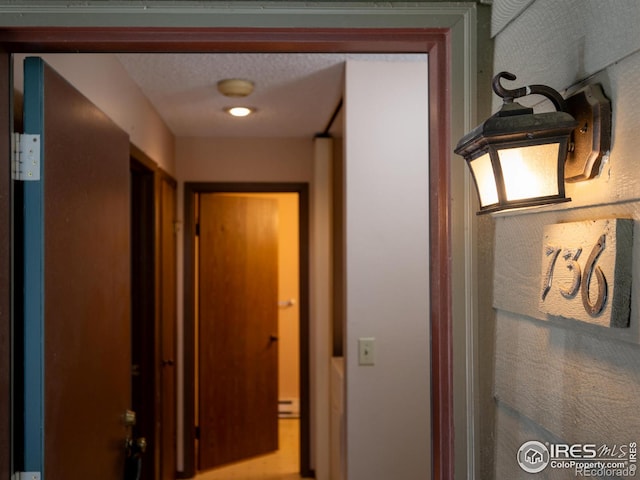 hallway with a textured ceiling