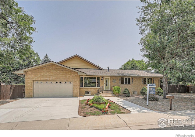 single story home featuring brick siding, an attached garage, and fence