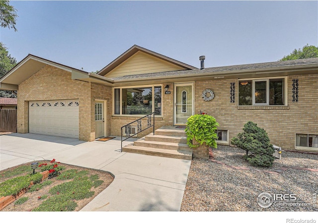 ranch-style home with concrete driveway, brick siding, and a garage