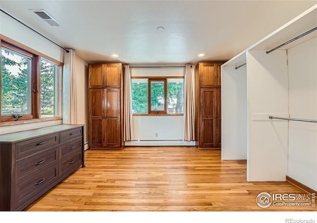 kitchen featuring recessed lighting, a baseboard heating unit, light wood-style floors, and visible vents