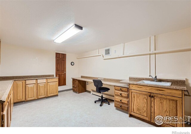 home office featuring sink, a textured ceiling, and baseboard heating