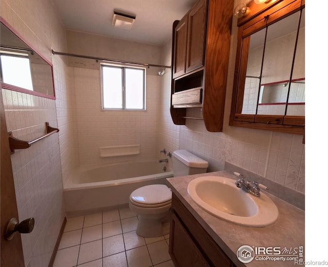619 Curtis St, Brush, CO 80723 - bathroom featuring washtub / shower combination, tile patterned floors, vanity, tile walls, and backsplash