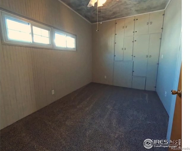 619 Curtis St, Brush, CO 80723 - empty room with dark colored carpet and a ceiling fan