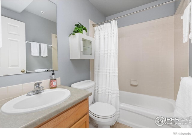 bathroom featuring tile patterned flooring, vanity, toilet, and shower / bath combo with shower curtain