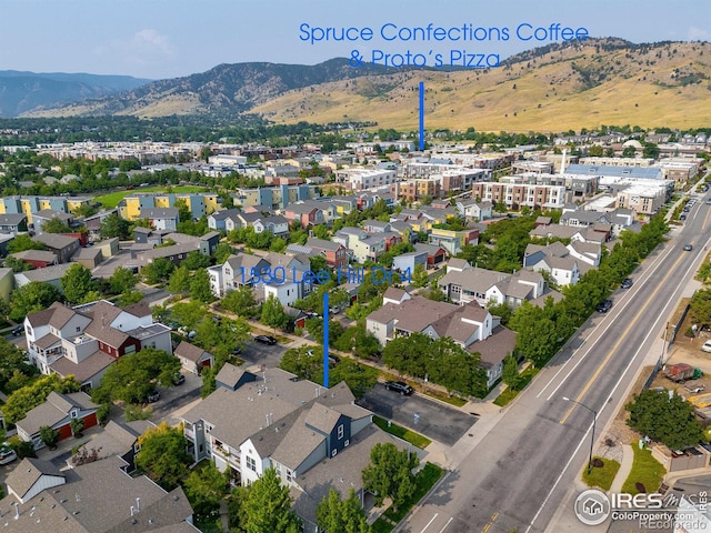 drone / aerial view featuring a residential view and a mountain view