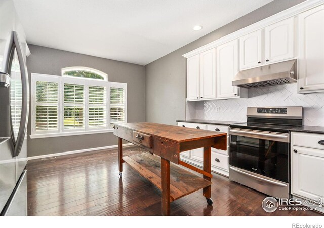 kitchen with white cabinets, backsplash, appliances with stainless steel finishes, and dark wood-type flooring