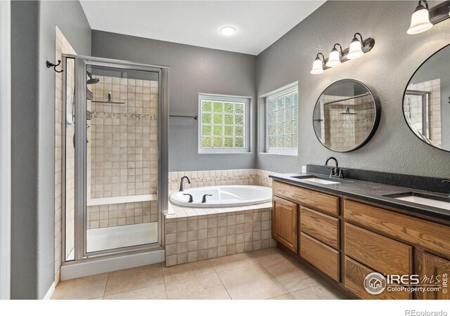 bathroom with dual vanity, tile patterned floors, and independent shower and bath