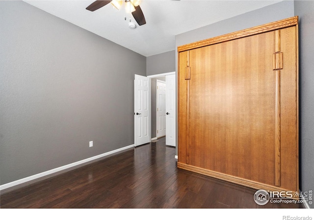 unfurnished bedroom featuring a closet, ceiling fan, and dark hardwood / wood-style floors