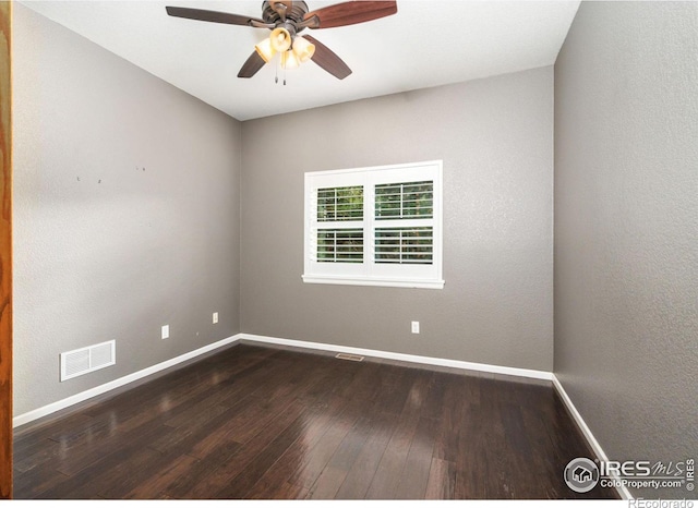 empty room with hardwood / wood-style floors and ceiling fan