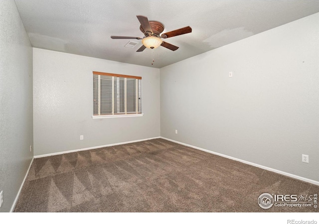 carpeted spare room with ceiling fan