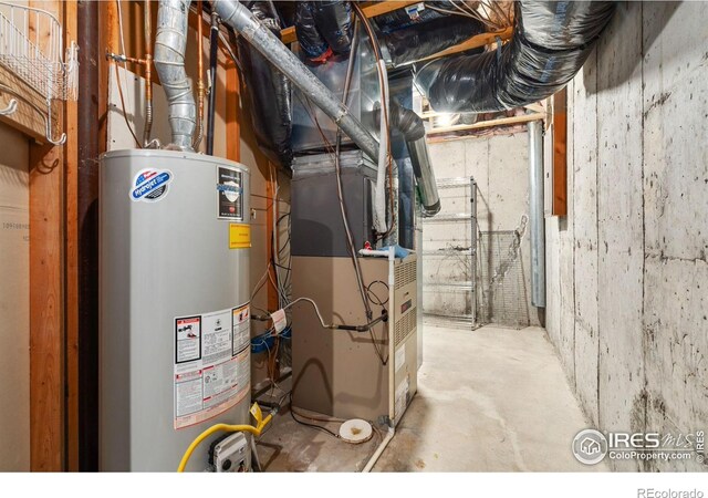 utility room featuring heating unit and gas water heater