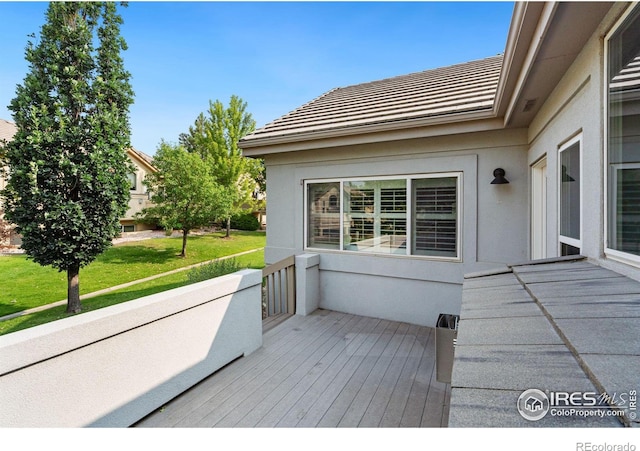 wooden deck featuring a yard