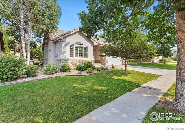 view of front of home with a garage and a front yard