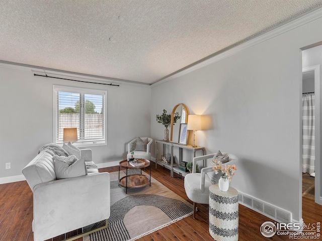 living room with crown molding, hardwood / wood-style floors, and a textured ceiling