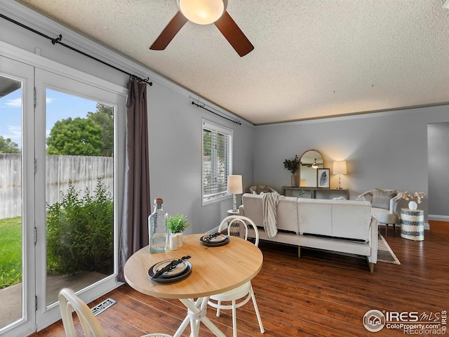 bedroom with dark hardwood / wood-style floors, ornamental molding, access to outside, ceiling fan, and a textured ceiling