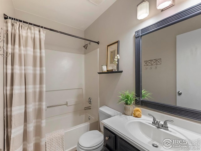 full bathroom with vanity, shower / bath combination with curtain, and toilet