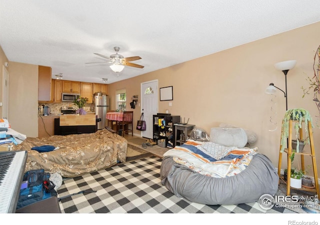 3300 Madison Ave, Boulder, CO 80303 - bedroom featuring light carpet, a textured ceiling, a ceiling fan, and freestanding refrigerator