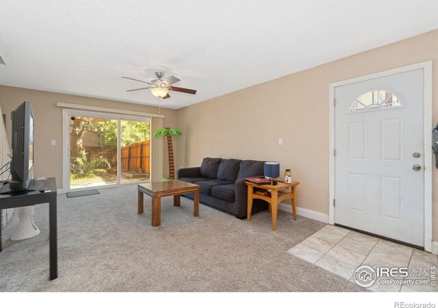 3300 Madison Ave, Boulder, CO 80303 - living area with light tile patterned flooring, light colored carpet, baseboards, and a ceiling fan