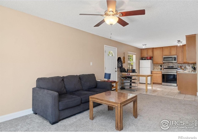 3300 Madison Ave, Boulder, CO 80303 - living room featuring light tile patterned floors, baseboards, a textured ceiling, ceiling fan, and light carpet