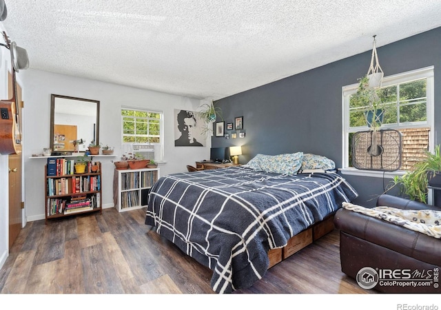 3300 Madison Ave, Boulder, CO 80303 - bedroom featuring baseboards, wood finished floors, and a textured ceiling