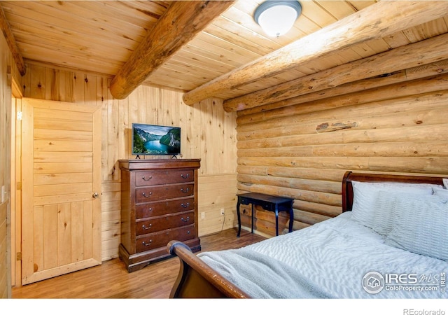 bedroom with wooden ceiling, log walls, wooden walls, beamed ceiling, and wood-type flooring